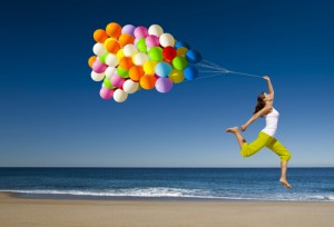 Woman running with balloons
