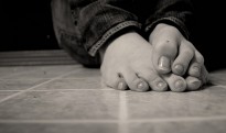 Womans feet on title floor Womans feet on title floor